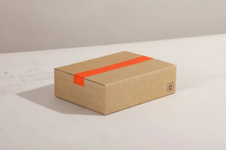 Cardboard box sealed with bright orange tape